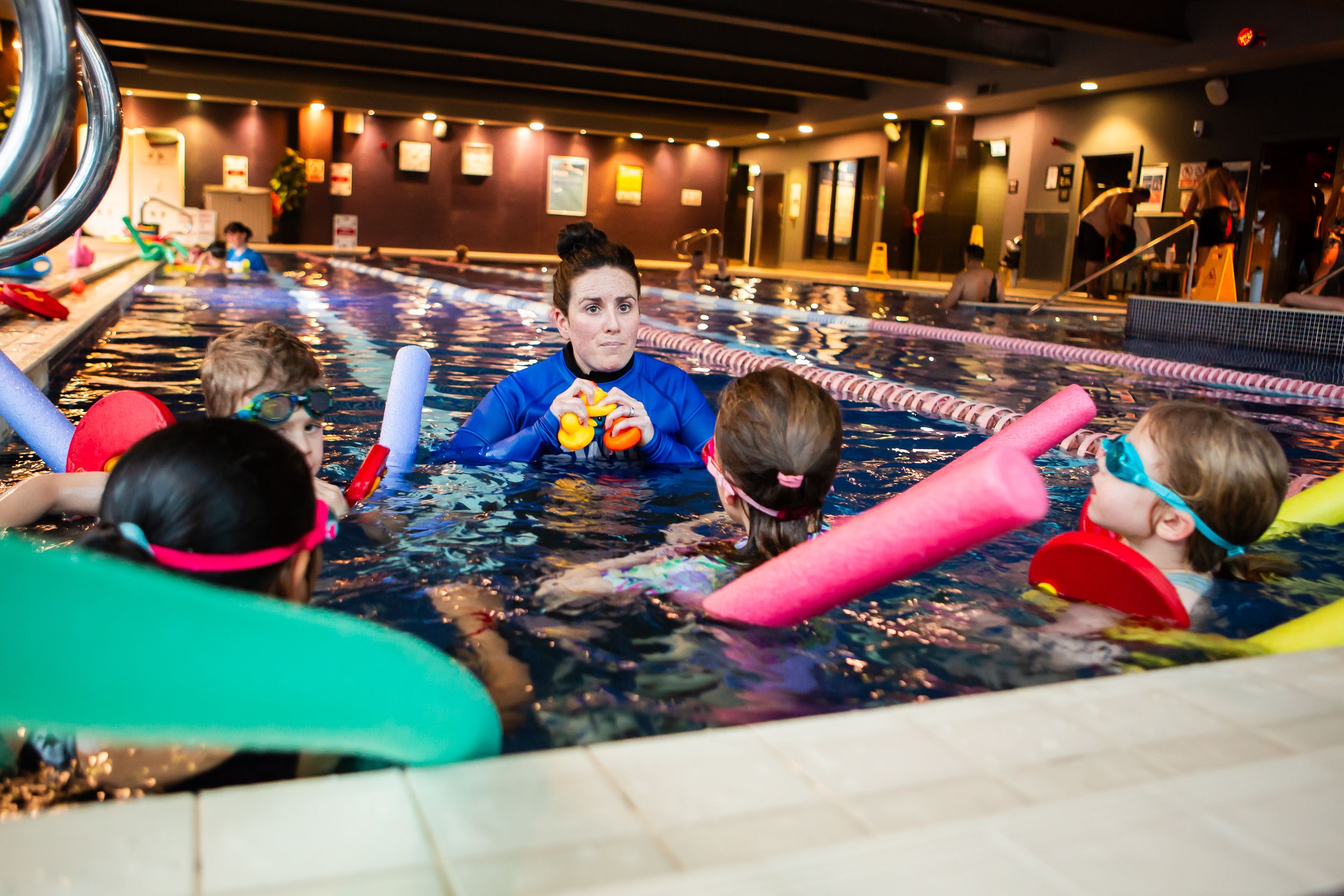 Swimming instructor in pool with children