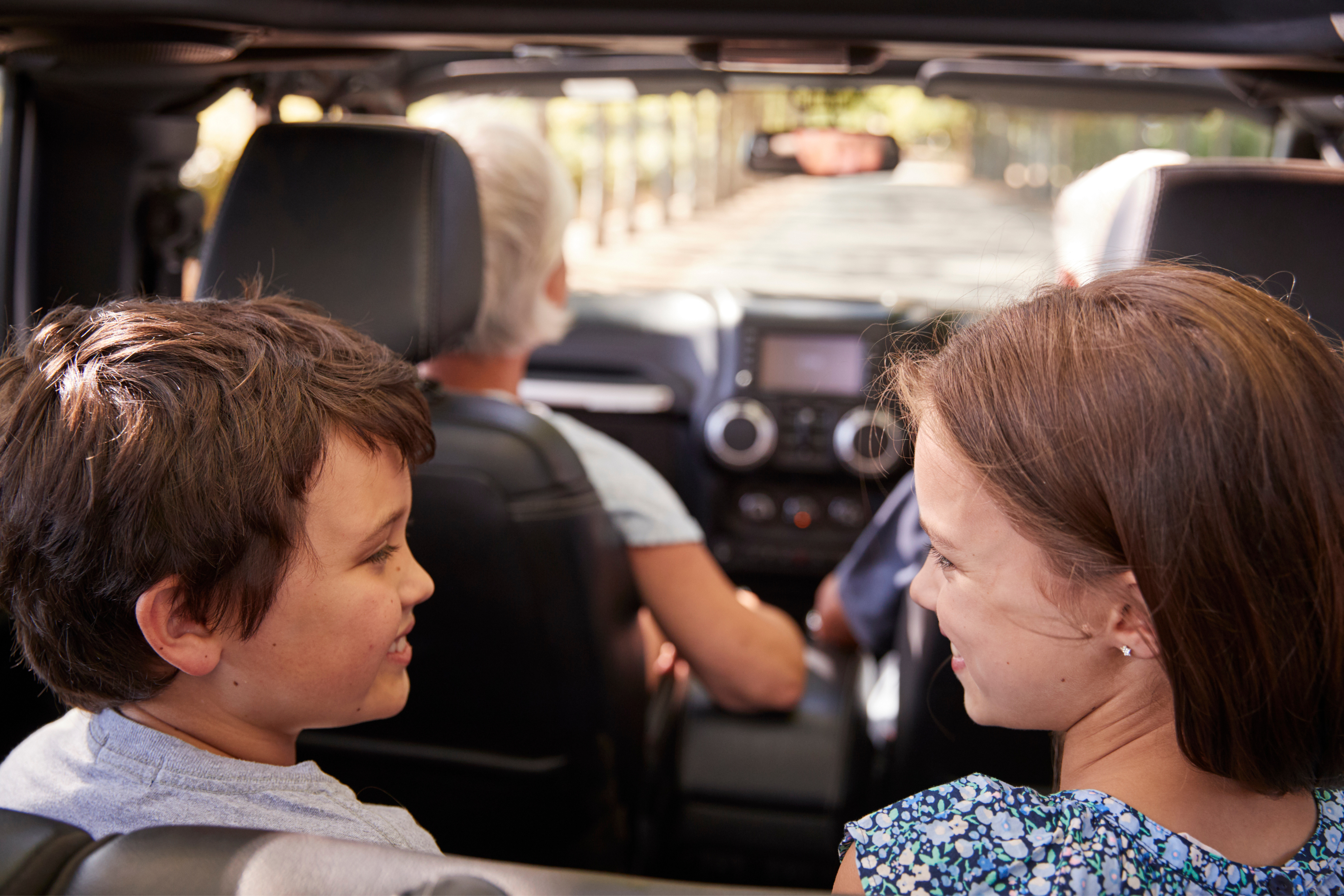 Grandparents driving children in the car
