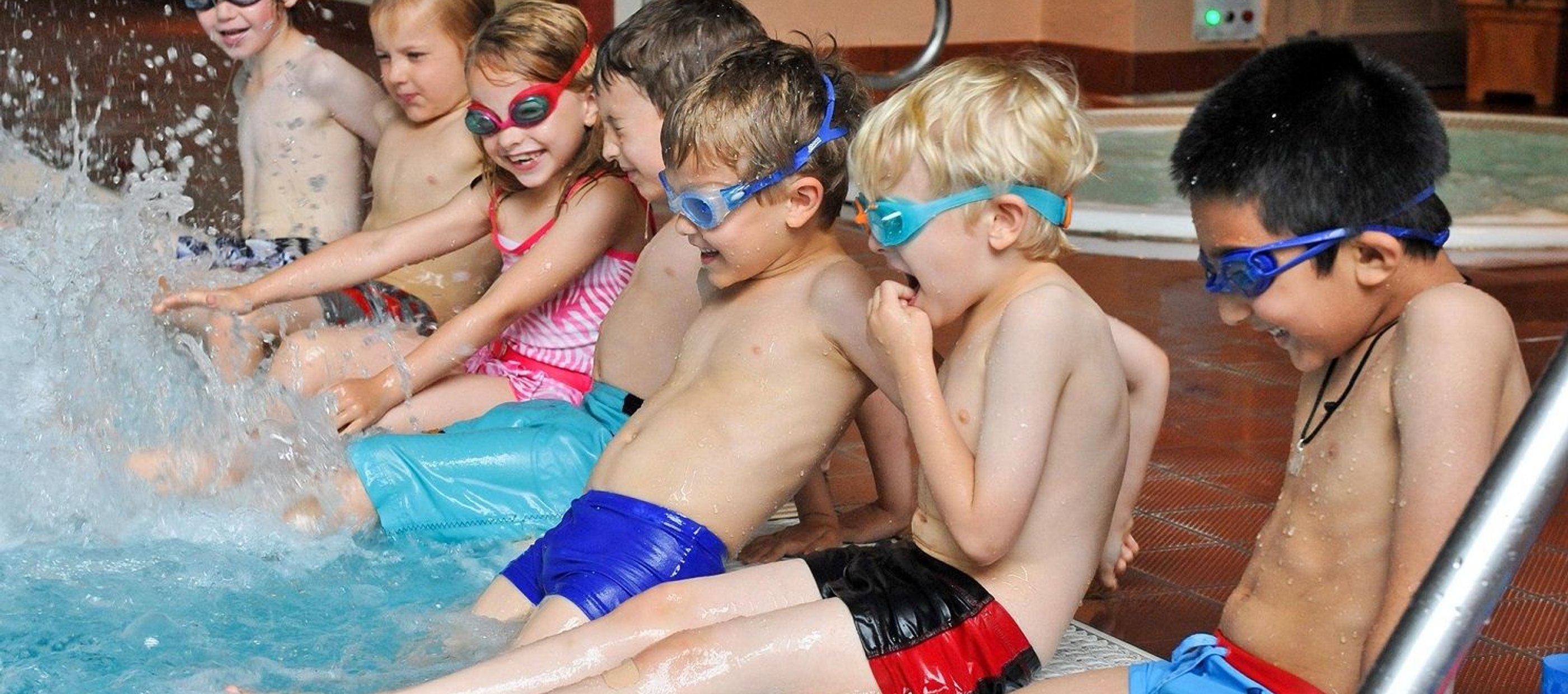 Children splashing on edge of pool