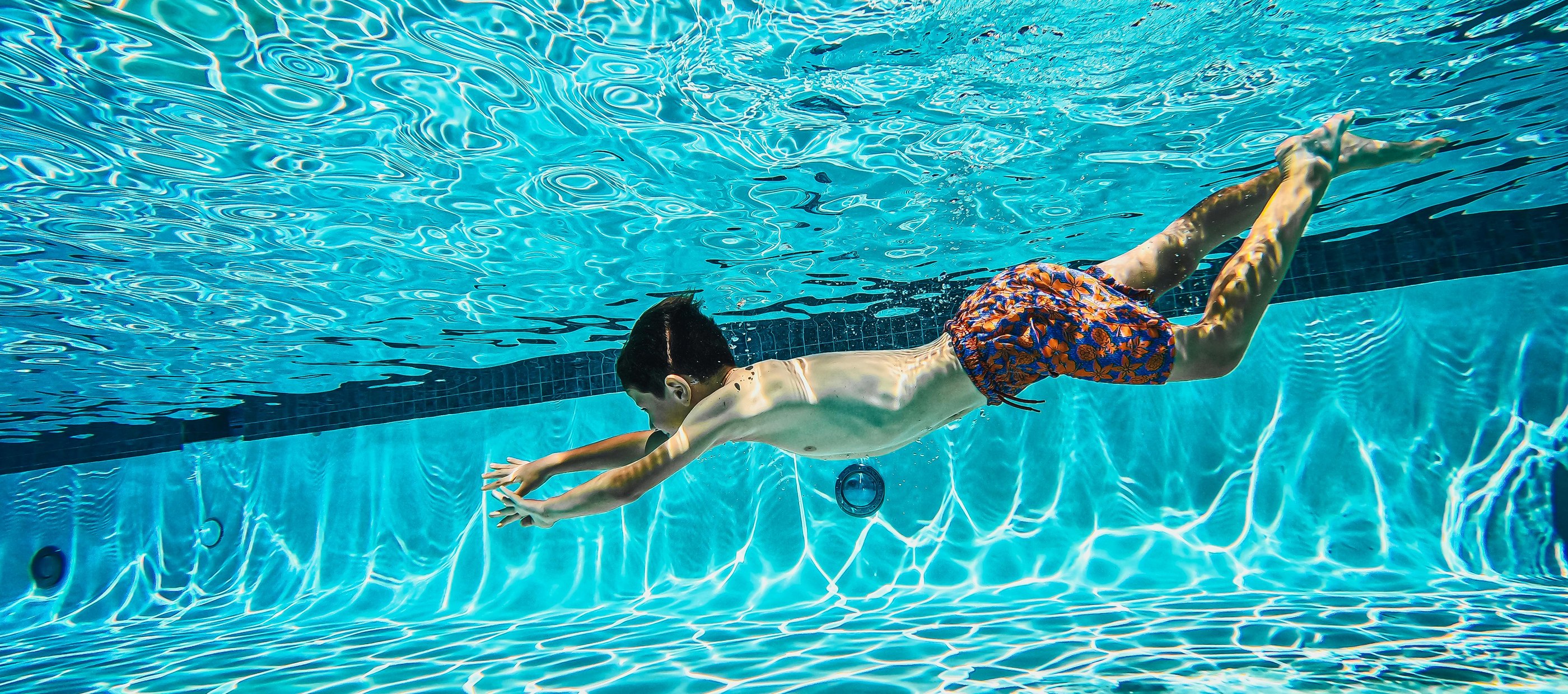 Child dives into a Swimming Pool